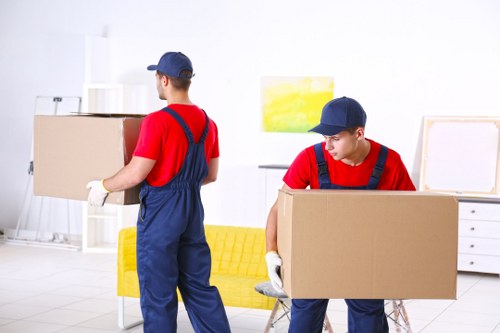 Local furniture pick-up team collecting a sofa from a home in Movingservices