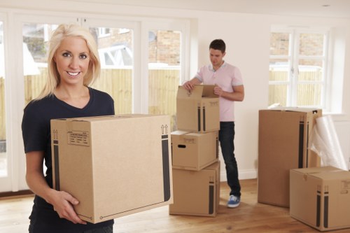 Professional movers carrying furniture through a narrow entrance