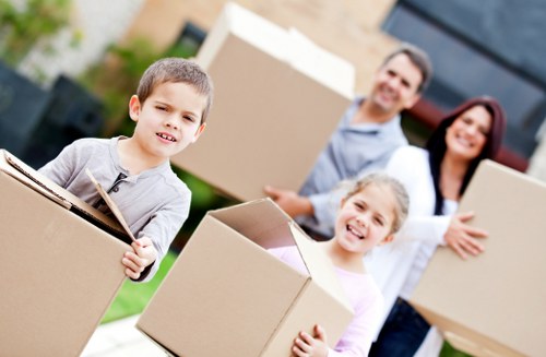 Movers loading commercial equipment carefully for transport