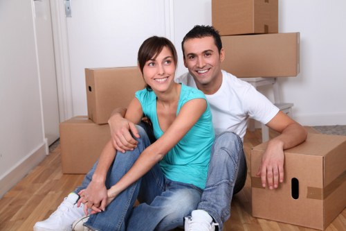 Residential moving team preparing boxes in a family home