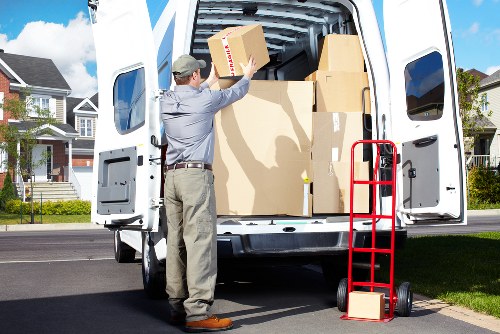 Packed office equipment and labelled moving boxes ready for transport