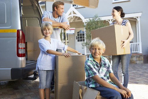 Moving crew handling boxes and furniture for a local relocation