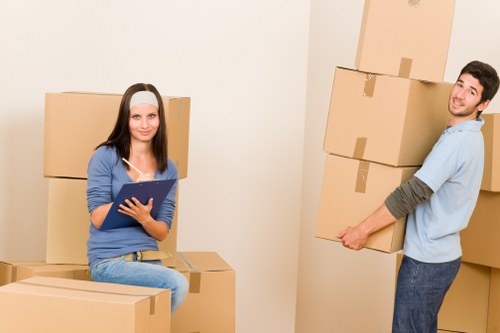 Removal team unloading boxes into the correct rooms at a new home
