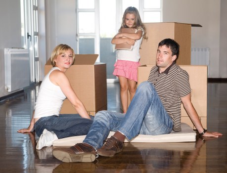 Movers loading packed boxes into a vehicle for a local relocation